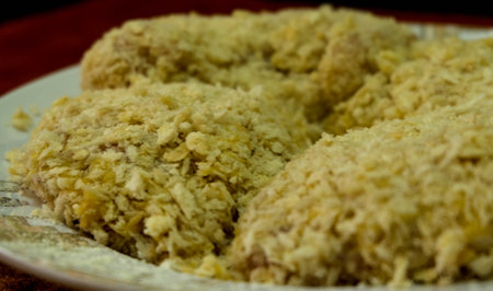 Chicken coated with breadcrumbs is ready to be fried, inside it is inserted mozzarella cheese to make it more delicious.の写真素材