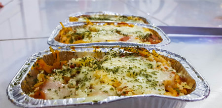Home-baked schotel macaroni or schaal macaroni. Is an Indonesian macaroni casserole dish made of pasta, cheese, milk, butter, meat, sausage, tuna, eggs, onions, mushrooms and sometimes potatoes.の写真素材