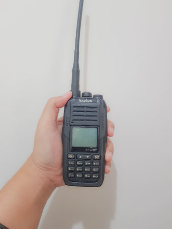 Jakarta, Indonesia in July 2022. A hand holds a handy talkie, a device used to communicate at close range by using radio frequencies.の写真素材