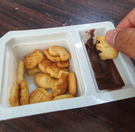 Crackes with a savory taste with chocolate dip with a sweet taste. Very tasty and suitable as a snack for children.の写真素材
