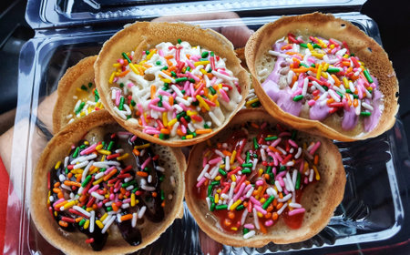 Martabak Mini, is a typical Indonesian pancake. Street food made from flour, yeast, eggs and sugar baked and topped with butter and chocolate sprinkles.の写真素材