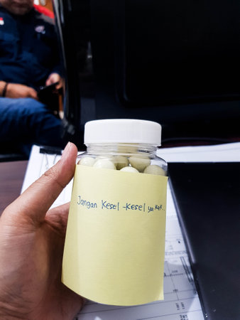 Jakarta, Indonesia in October 2022. A hand holds a jar of white chocolate, a gift from a friend.の写真素材