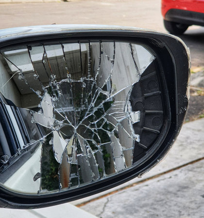 A car's right side rearview mirror was broken when it was hit by another vehicle. This broken glass must be replaced immediately because it will be very annoying and make it uncomfortable when driving.の写真素材