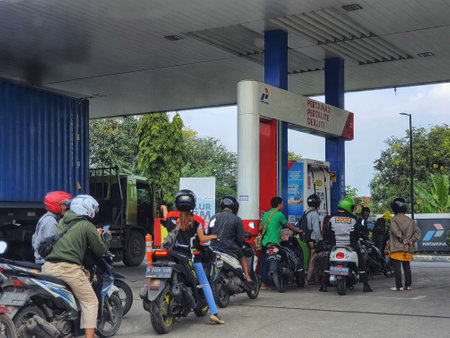 West Java, Indonesia in September 2022. Motorcyclists queue long enough at Pertamina gas stations to buy fuel for their motorbikes. Even though the price of pertalite goes up they still buy it because of their daily needs.のeditorial素材