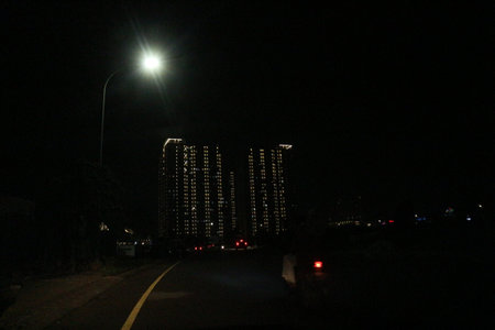 Conditions at night where you can see neatly arranged light rays coming from an apartment where the lights are on in each room.の写真素材