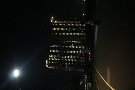 Conditions at night where you can see neatly arranged light rays coming from an apartment where the lights are on in each room.の写真素材