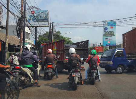West Java, Indonesia in September 2022. Road congestion or vehicle density that occurs on Jalan Raya Bekasi. This road is often jammed because of large vehicles turning back.のeditorial素材