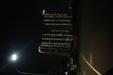 Conditions at night where you can see neatly arranged light rays coming from an apartment where the lights are on in each room.の写真素材