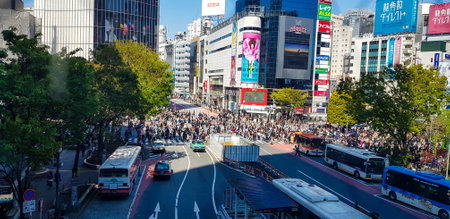 Japan on April 2019. Shibuya Scramble Crossing is a popular scramble crossing in Shibuya, Tokyo, Japan. It is located in front of the Shibuya Station HachikÅ exit and stops vehicles in all directions to allow pedestrians to inundate the entire intersectiのeditorial素材