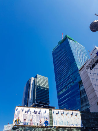 Japan on April 13, 2019. Billboards advertising banners of new boyband or idol grup in Japan between tall building in front of Shibuya Train Station, Japan.のeditorial素材