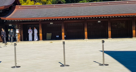 Japan on April 2019. A Japanese Shinto wedding ceremony process at Meiji Shrine. The groom wears a black kimono and the bride wears a white kimono. It is very attractive to tourists who are visiting Meiji Shrine.のeditorial素材