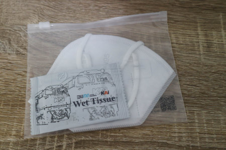 West Java, Indonesia in October 2022. This is a health kit against covid from PT. KAI Kereta Api Indonesia, which consists of a mask and wet tissue in a plastic pouch on a wooden table.のeditorial素材