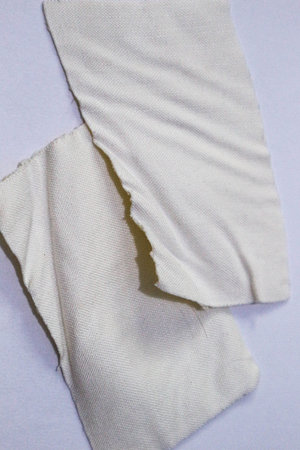 A pile of used patches that are bent and there are traces of hair pulled out and attached to the...