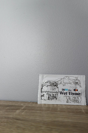West Java, Indonesia in October 2022. This is a wet tissue issued by PT. KAI Kereta Api Indonesia on a wooden table.のeditorial素材