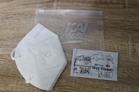 West Java, Indonesia in October 2022. This is a health kit against covid from PT. KAI Kereta Api Indonesia, which consists of a mask and wet tissue in a plastic pouch on a wooden table.のeditorial素材