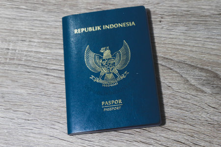 Indonesian green passport on a wooden table. This passport is an identity for Indonesian citizens who are going abroad.の写真素材