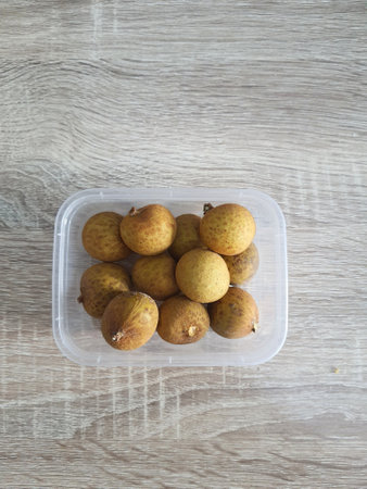 Complementary food supplies for meal box children, in the form of fruit. A small plastic box containing longans fruit. Contains lots of vitamins and antioxidants.の写真素材