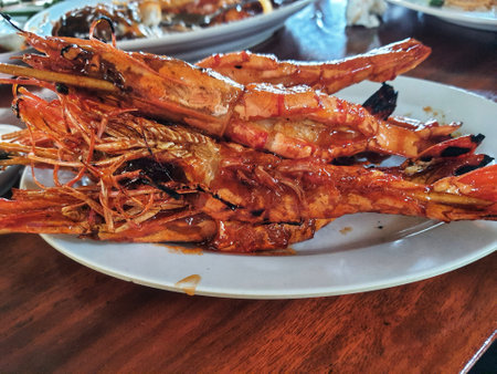 Honey spiced grilled prawns, a typical Indonesian seafood dish that has a savory and sweet taste that is perfectly balanced with a delicious aroma. Beautifully served in a restaurant.の写真素材