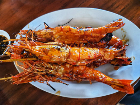 Honey spiced grilled prawns, a typical Indonesian seafood dish that has a savory and sweet taste that is perfectly balanced with a delicious aroma. Beautifully served in a restaurant.の写真素材