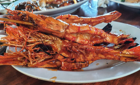 Honey spiced grilled prawns, a typical Indonesian seafood dish that has a savory and sweet taste that is perfectly balanced with a delicious aroma. Beautifully served in a restaurant.の写真素材
