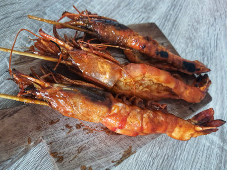 Honey spiced grilled prawns, a typical Indonesian seafood dish that has a savory and sweet taste that is perfectly balanced with a delicious aroma. Beautifully served in a restaurant.の写真素材