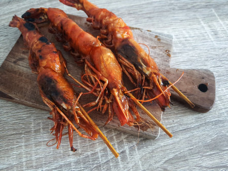 Honey spiced grilled prawns, a typical Indonesian seafood dish that has a savory and sweet taste that is perfectly balanced with a delicious aroma. Beautifully served in a restaurant.の写真素材