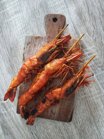 Honey spiced grilled prawns, a typical Indonesian seafood dish that has a savory and sweet taste that is perfectly balanced with a delicious aroma. Beautifully served in a restaurant.の写真素材