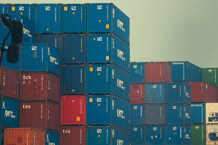 jakarta, Indonesia in October 2022. Stacks of containers of various colors are in an export-import warehouse. This warehouse is guarded by a security guard so that no one enters carelessly.の写真素材
