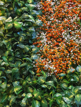 Imitation plants in the form of orange-brown flowers and green leaves are very beautiful and can be used as a background or backdrop.の写真素材