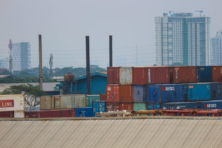 jakarta, Indonesia in October 2022. Stacks of containers of various colors are in an export-import...