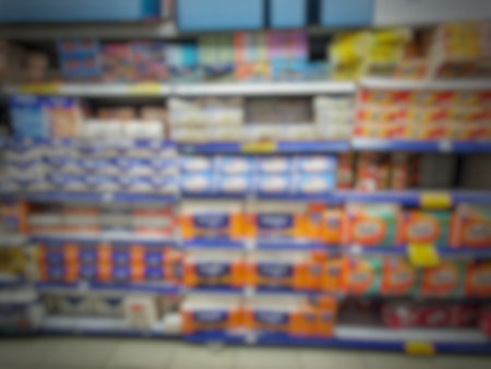 This is a blur photo of a supermarket or mall storefront containing various items.