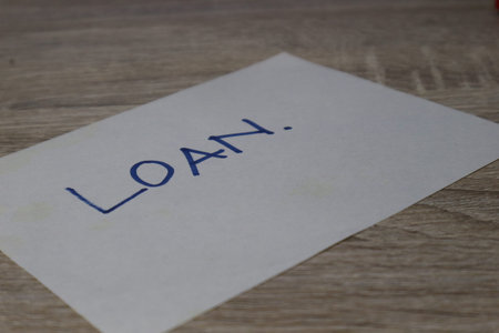 A paper with the words Loan, as an illustration related to business and finance.