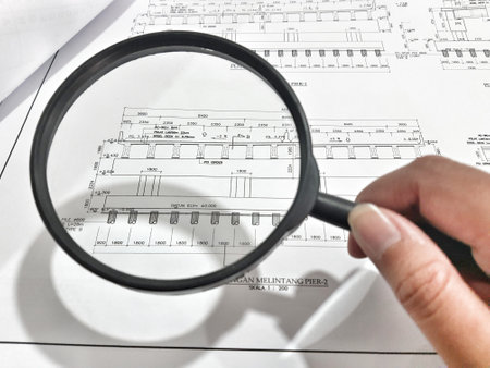 A magnifying glass is often used to view and magnify detailed shop drawings, or engineering drawings for bridge structures.の写真素材