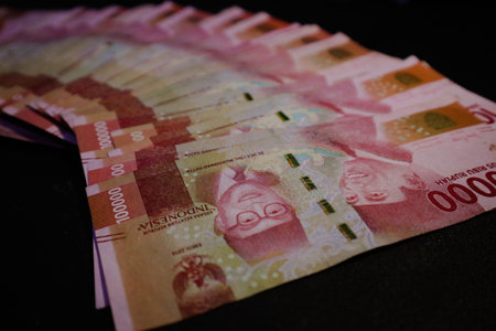 Several hundred thousand rupiah coins were scattered. It is perfect for your template background, or for news related to business and finance.の写真素材