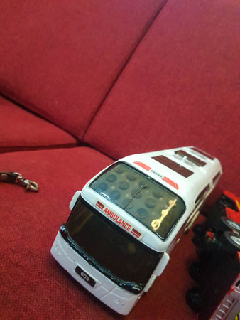 Jakarta, Indonesia in December 2022. Toys for boys lying on a red chair, ambulances and fire trucks.の写真素材