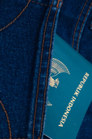An Indonesian citizenship passport in a jeans pocket. This photo is suitable as an illustration of traveling abroad.の写真素材
