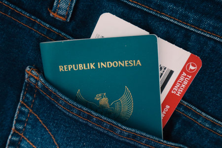 Indonesia in July 2022. An Indonesian passport and a Turkish Airlines boarding pass in a jeans pocket. This photo is suitable as an illustration of traveling abroad.のeditorial素材