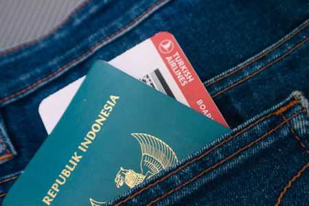 Indonesia in July 2022. An Indonesian passport and a Turkish Airlines boarding pass in a jeans pocket. This photo is suitable as an illustration of traveling abroad.のeditorial素材