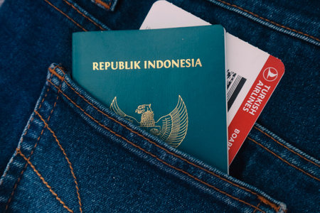 Indonesia in July 2022. An Indonesian passport and a Turkish Airlines boarding pass in a jeans pocket. This photo is suitable as an illustration of traveling abroad.のeditorial素材