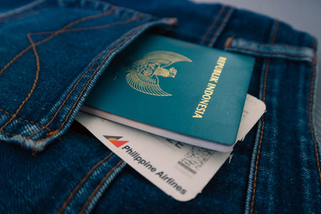 Indonesia in July 2022. An Indonesian passport and a Philippines Airlines boarding pass in a jeans pocket. This photo is suitable as an illustration of traveling abroad.のeditorial素材