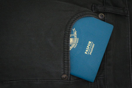 An Indonesian citizenship passport in a green denim pocket. This photo is suitable as an illustration of traveling abroad.の写真素材