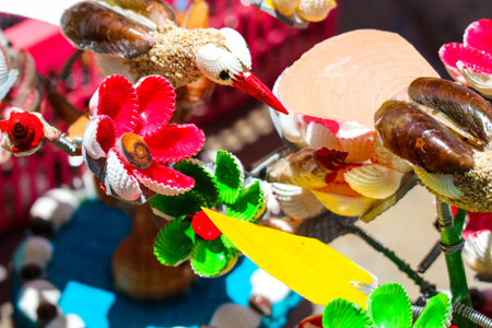 Beach souvenirs, craft miniature birds and flowers made from colorfully painted shells. Very pretty and beautiful. Moving in the wind. At Baron Beach, Gunung Kidul, Jogjakarta.の写真素材