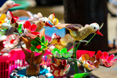 Beach souvenirs, craft miniature birds and flowers made from colorfully painted shells. Very pretty and beautiful. Moving in the wind. At Baron Beach, Gunung Kidul, Jogjakarta.の写真素材