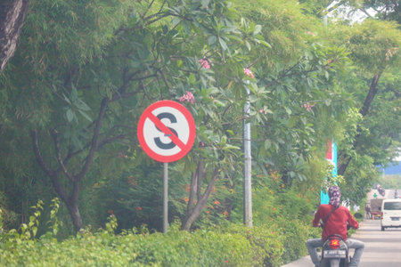 Jakarta, Indonesia in November 2022. Back view of a motorcyclist driving on a busy street on the outskirts of Jakarta.のeditorial素材