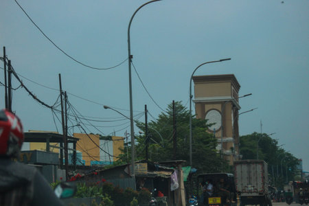 Jakarta, Indonesia in November 2022. Back view of a motorcyclist driving on a busy street on the outskirts of Jakarta.のeditorial素材