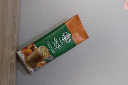 Bekasi, Indonesia on July 2022. Copy space starbucks caramel latte sachet, Starbucks premium instant coffee sachet original from Turkey. We can enjoy Starbucks coffee easily from home.のeditorial素材