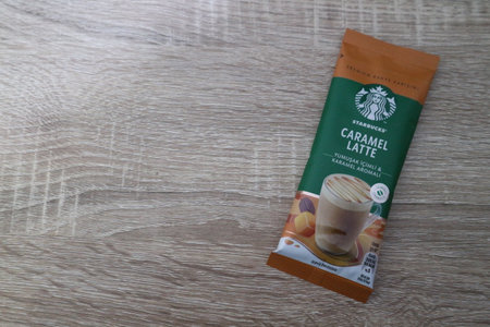 Bekasi, Indonesia on July 2022. Copy space starbucks caramel latte sachet, Starbucks premium instant coffee sachet original from Turkey. We can enjoy Starbucks coffee easily from home.のeditorial素材