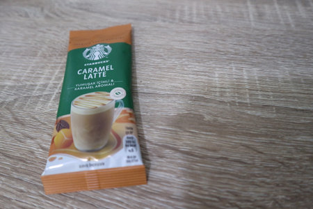 Bekasi, Indonesia on July 2022. Copy space starbucks caramel latte sachet, Starbucks premium instant coffee sachet original from Turkey. We can enjoy Starbucks coffee easily from home.のeditorial素材