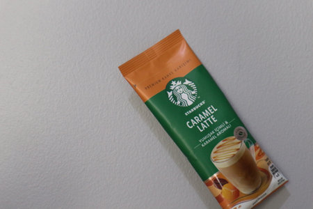 Bekasi, Indonesia on July 2022. Copy space starbucks caramel latte sachet, Starbucks premium instant coffee sachet original from Turkey. We can enjoy Starbucks coffee easily from home.のeditorial素材