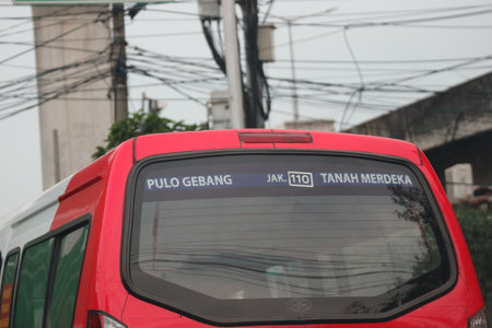 Jakarta, Indonesia in July 2022. Public transportation is in the form of a small passenger car owned by the DKI Jakarta government with Code JAK 110 with the Pulo Gebang route to Tanah Merdeka and vice versa. This public transportation uses a red car.のeditorial素材